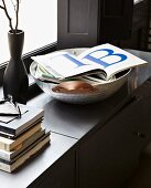 Open book of large letters on grey sideboard