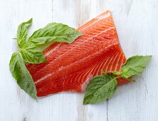 A Fresh Filet of Salmon with Fresh Basil Leaves