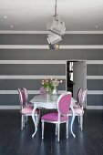 Neo Rococo chairs in silver and pink around dining table and grey and white striped wall in elegant, minimalist interior