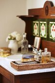 Wicker tray of toiletries on vintage washstand with marble top
