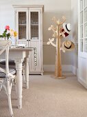 Stylised tree as hat stand, dresser and Scandinavian, country-house-style dining set