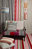 Colourful striped designs on fabric swatches, armchair and lampshade