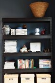 Boxes, books & ornaments on black metal shelving