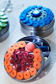 Small metal tins with lids decorated with buttons