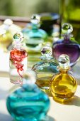Collection of glass perfume bottles filled with fluids of various colours