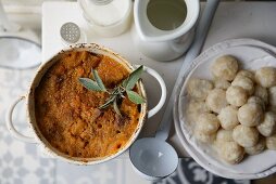 A stew of pork, apple, carrots and sage with dumplings