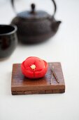 Wagashi camellia (tsubaki) with a teapot (Japan)