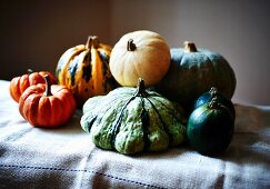 Assorted types of squash on a linen cloth