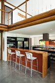 Open-plan kitchen with counter and barstools