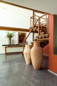 Interior with wooden staircase and floor vases