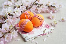 Sprigs of cherry blossom & dyed eggs wrapped with yarn