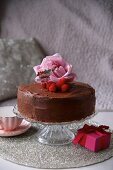 Chocolate cake decorated with raspberries and roses for Valentine's Day