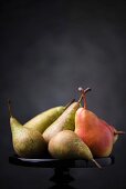 Several pears on a cake stand