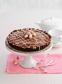 An Easter-themed chocolate cake on a cake stand