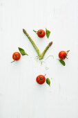A clock face made from tomatoes and green asparagus
