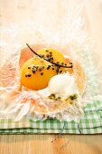 Peach baked in foil with passion fruit, vanilla and rosemary ice cream