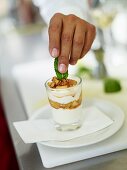 Apple and cinnamon compote with mascarpone cream, a walnut and a mint leaf