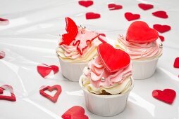 Pink cupcakes with red hearts and butterflies