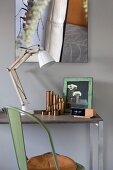 Vintage chair, small desk, modern lamp and artistic photo