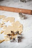 Rolled-out biscuit dough with a star cutter and rolling pin