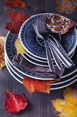 Stacked plates and painted autumn leaves