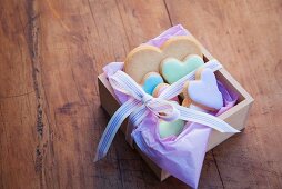 Heart-shaped biscuits in a wooden box with a ribbon