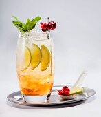 Fruit cocktail with berries, limes and mint on a silver tray