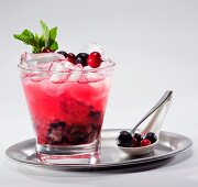 Fruit cocktail with wild berries on a silver tray