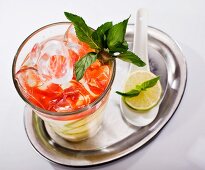 Cocktail with tomato and lemon juice, on a silver tray