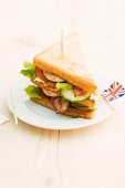 Toasted club sandwich with bacon, cucumber and tomato (England)