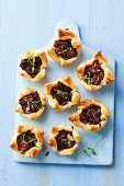 Puff pastry tartlets with caramelised red onions, sundried tomatoes and thyme