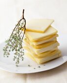 Raclette cheese, sliced, on a plate