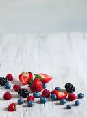 Assorted fresh berries on a wooden surface