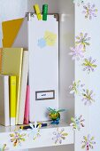 Flower shapes punched out of map decorating white shelving