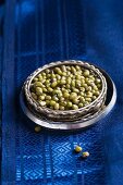 Mung beans on a blue silk sari in a stack of Indian bangles