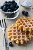 Waffles with icing sugar and fresh blueberries