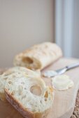 Ciabatta and butter on a chopping board