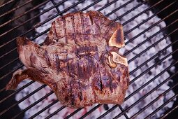 A T-bone steak on a barbecue