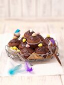 Chocolate muffins decorated with sugared eggs for Easter