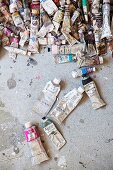 Many used tubes of paint on concrete floor