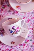 Floral-patterned teacups with a gold rim