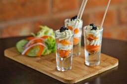 Smoked salmon with cream and caviar served in shot glasses