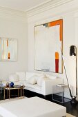 Contemporary painting on wall above chaise sofa and sculpture of enormous safety pin in elegant interior belonging to art collector