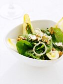 A mixed leaf salad with walnuts and onions