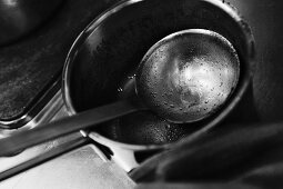 A dirty saucepan and a ladle