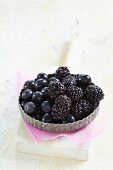 Blueberries and blackberries in a tartlet dish