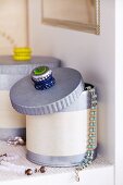 Stacked bottle tops stuck to lid of jewellery box as handle