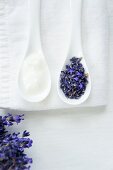 Lavender flowers and lavender cream on porcelain spoons