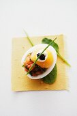 An egg with salmon tartar, crème fraîche and caviar