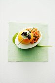 An egg with salmon tartar, crème fraîche and caviar
